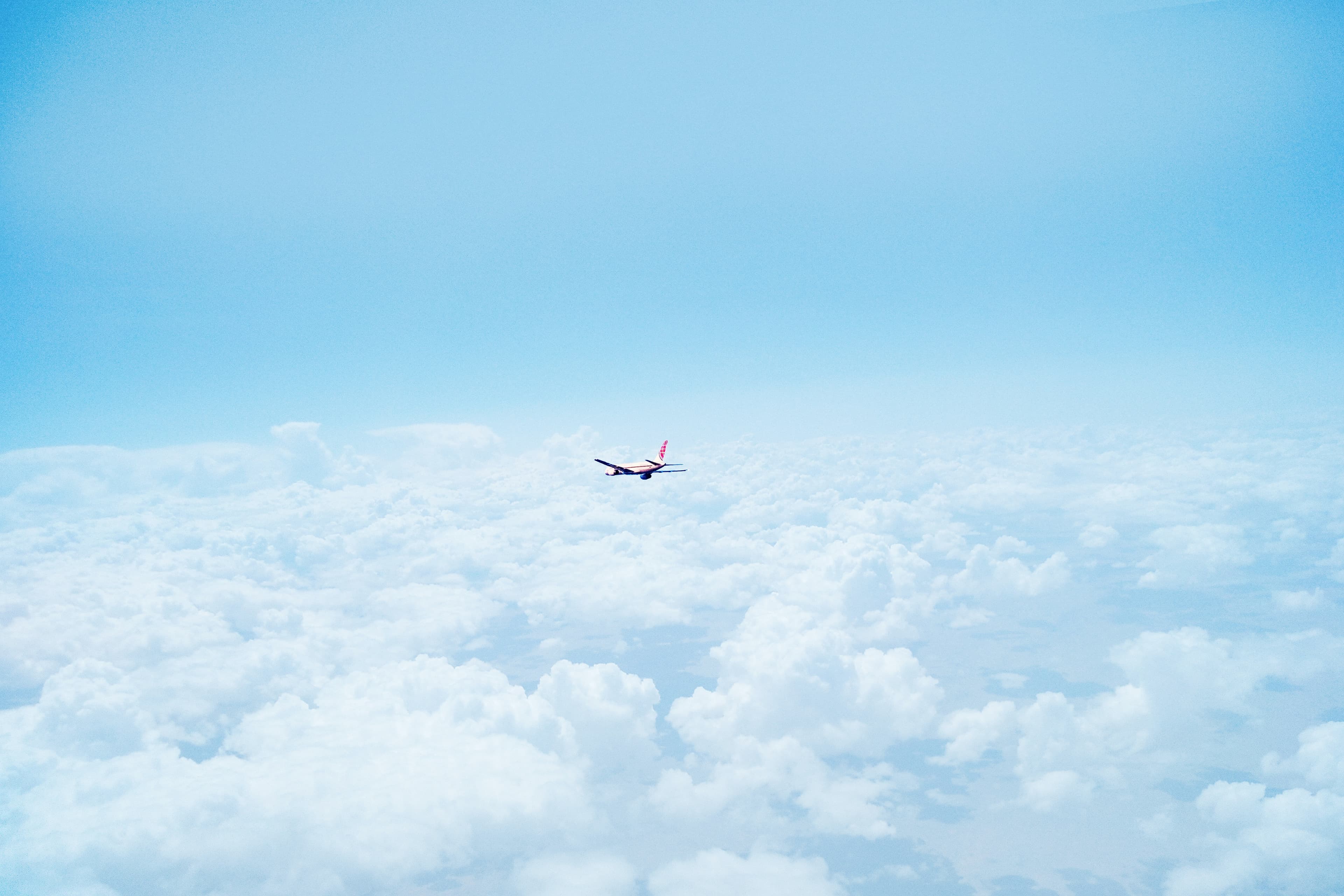Private jet flying through clouds